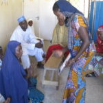 Hussiana teaching local health workers about solar electricity