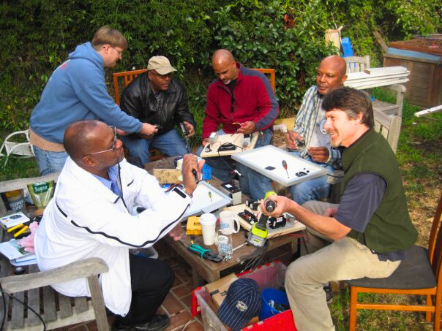 Hal Aronson and Mike Strykowski teaching volunteers to build Solar Suitcases for Haiti after 2010 earthquake